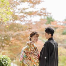 鎌倉・海蔵寺で秋に撮影した和装前撮り 鎌倉・海蔵寺で色打掛を着用した新婦と紋付袴を着用した新郎が手を繋いでほほ笑む和装前撮り
