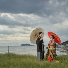 鎌倉・稲村ガ崎で秋に撮影した和装前撮り 鎌倉・稲村ガ崎で色打掛を着用した新婦と紋付袴を着用した新郎が番傘を持ち立っている和装前撮り