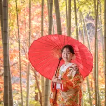 鎌倉・建長寺で秋に撮影した和装前撮り 鎌倉・建長寺で色打掛を着用した新婦が番傘を持ってほほ笑んでいる和装前撮り