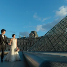 パリで夏に撮影した洋装前撮り パリでウェディングドレスを着用した新婦とタキシードを着用した新郎が手を繋いで写る洋装ウェディングフォト