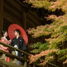 鎌倉和洋装S様・S様 2019.12.23 紅葉する寺院の回廊で、「結婚しました」のガーランドを掲げる色打掛の新婦と黒紋付袴の新郎